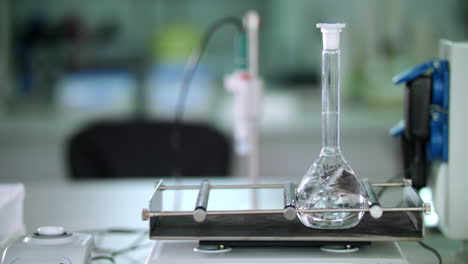 Glass-flask-at-laboratory-shaker.-Closeup-of-medical-laboratory-equipment